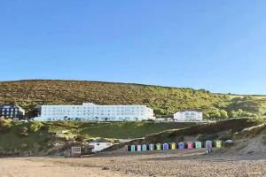 a building on a hill next to a beach at Tarka Holiday Park - Summer Breeze - Coastal Breaks - North Devon - Braunton-Barnstaple in Ashford