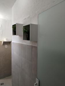 a kitchen with white walls and a wall with three pictures at Cantinho da Paz in Socorro +28 photos