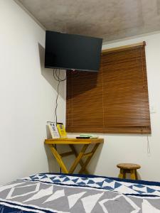 a bedroom with a bed and a window with a television at Bogotá Kings 302 in Bogotá
