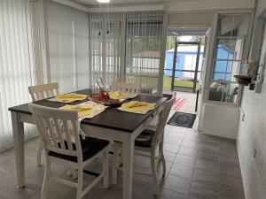 a dining room with a table with chairs and a tableablish at Beautiful Vacation Spot! in Beverly Hills