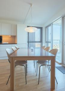 a dining room with a wooden table and chairs at Stunning Sea View / 1 bedroom apartment / Tórshavn in Tórshavn