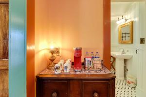 a bathroom with a vanity with a sink and a counter top at Victorian Vacation Rental Apt in Downtown New Bern in New Bern +21 photos
