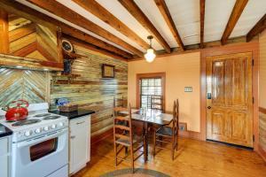 a kitchen with wooden walls and a table and a stove at Victorian New Bern Vacation Rental In Downtown! in New Bern