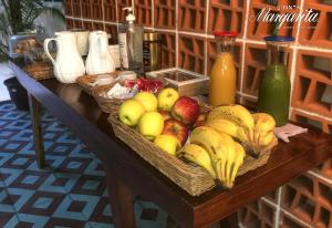 a table with baskets of fruit on top of it at Quinta Margarita - Boho Chic Hotel in Playa del Carmen