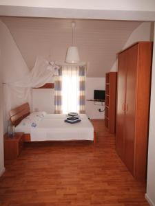 a bedroom with a white bed and a window at Apartments by the sea Bol, Brac - 2904 in Bol