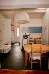 a kitchen with a wooden table and chairs in it at Apartments by the sea Bol, Brac - 2904 in Bol