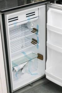 an empty refrigerator with its door open in a kitchen at Exclusive on Rio Negro in Montevideo