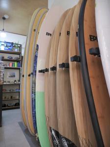 a row of surfboards lined up against a wall at Villas El Beach Club in Santa Cruz