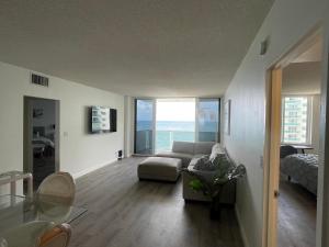 a living room with a couch and a table at MAGNIFICENT 2 bedroom /2 bath beachfront with Beach View Condo apartment in Hollywood