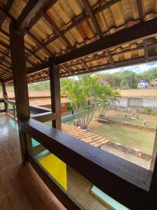 a view from the inside of a house with a large window at Pousada por do soll in Serra do Cipo