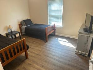 1 dormitorio con 1 cama y TV en Brookwood en Chattanooga