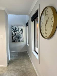 a large clock on a wall in a hallway at 44onRoaring - in the Huon Valley in Surveyors Bay