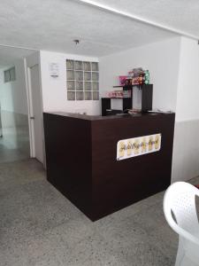 an office with a desk and a counter in a room at HOTEL BOGOTA AIRPORT DORADO in Bogotá