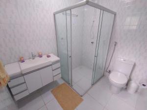 ein weißes Badezimmer mit Dusche und Toilette in der Unterkunft Linda casa em Guaramiranga in Guaramiranga