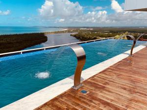 een infinity pool met uitzicht op een rivier bij Paiva Flats By Loui in Recife