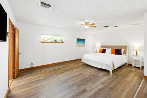 a bedroom with a bed and a ceiling fan at ~New~ Bright and Spacious Back House in Bakersfield