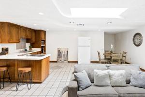 a kitchen and a living room with a couch and a table at ~New~ Bright and Spacious Back House in Bakersfield