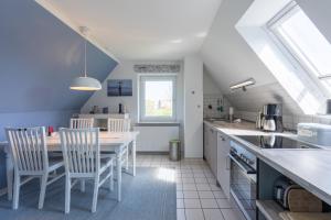 a kitchen with a table and chairs in a room at Pura Vida 2 in Tating