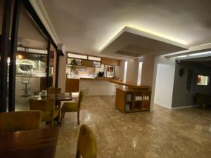 a room with a table and chairs and a kitchen at NFK The House Hotel in Antalya