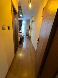 a hallway with a door leading to a living room at NFK The House Hotel in Antalya