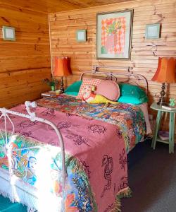 a bedroom with a bed in a log cabin at NOFOMO AT ADVENTURE BAY in Adventure Bay
