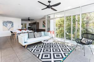 a living room with a couch and a table at Coastal Luxury, Private Pool, Ocean Vista in Sunshine Beach