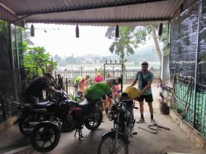 a group of men working on motorcycles in a garage at Zoni House-Yen Bai in Xóm Soi (2)