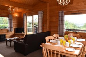 a dining room with a table and a couch at Hillside View in Rhayader