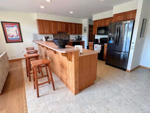 a kitchen with a large island with a refrigerator at SH3 Luxurious Stonehill Townhouse in Bretton Woods with Magnificent View in Bretton Woods