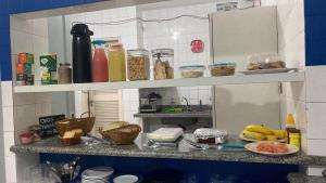 a kitchen with a counter with food on it at Pousada Fagundes Varela in Niterói