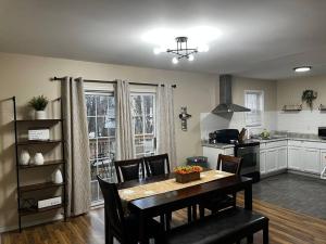 a kitchen and dining room with a table and chairs at Cozy cottage by the lake in Tobyhanna