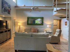 a living room with a couch and a television at Gated Gulf Front Condo in Hidden Dunes Beach & Tennis Resort in Destin
