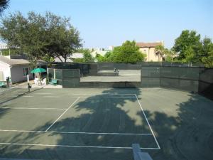 a tennis court with a tennis court at Gated Gulf Front Condo in Hidden Dunes Beach & Tennis Resort in Destin
