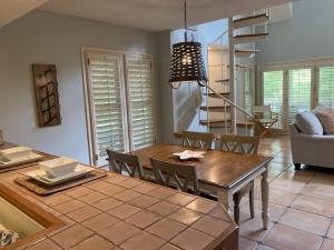 a kitchen and dining room with a table and chairs at Gated Gulf Front Condo in Hidden Dunes Beach & Tennis Resort in Destin