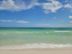 a view of a beach with the ocean at Gated Gulf Front Condo in Hidden Dunes Beach & Tennis Resort in Destin