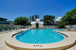 a large swimming pool with blue water at Gated Gulf Front Condo in Hidden Dunes Beach & Tennis Resort in Destin