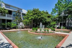 a fountain in front of a building at Gated Gulf Front Condo in Hidden Dunes Beach & Tennis Resort in Destin