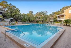 a large swimming pool with blue water at Gated Gulf Front Condo in Hidden Dunes Beach & Tennis Resort in Destin