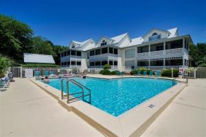 a large apartment building with a large swimming pool at Gated Gulf Front Condo in Hidden Dunes Beach & Tennis Resort in Destin