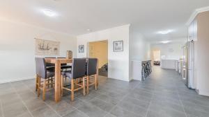 a kitchen and dining room with a table and chairs at 3-83 Thompson Avenue, Cowes in Cowes