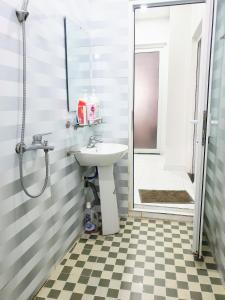 a bathroom with a sink and a shower at Mihome in Hai Phong