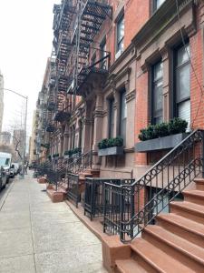 a building with stairs and potted plants on it at Private one bedroom one bathroom in New York