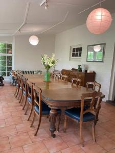 a dining room with a wooden table and chairs at York Cottage. A Country Retreat in Burradoo. in Burradoo