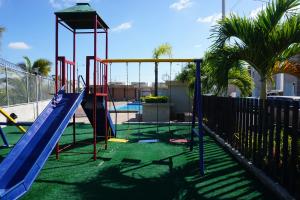 a playground with a slide in a yard at Casa Familiar con Piscina en Urbanización privada in Manta