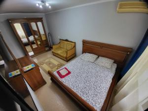 an overhead view of a bedroom with a bed and a chair at Уютная 1 комнатная квартира in Atyrau