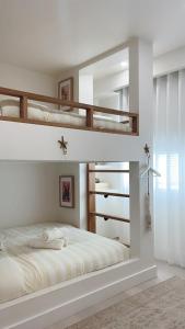 a bedroom with two bunk beds and a mirror at AQUA SHOAL BAY in Shoal Bay