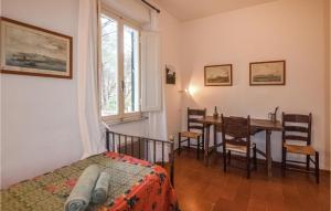 a bedroom with a table and chairs and a window at Amazing Home In San Pietro In Campo With Wifi in San Piero in Campo