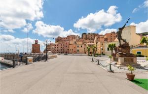 a bridge with a large building in the background at Amazing Home In San Pietro In Campo With Wifi in San Piero in Campo