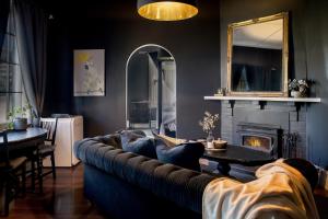 a living room with a couch and a fireplace at Piney Ridge, the Butler's Cottage 