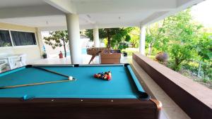 a pool table on the back porch of a house at Fun Guest House with Pool near Troodos in Perapedhi